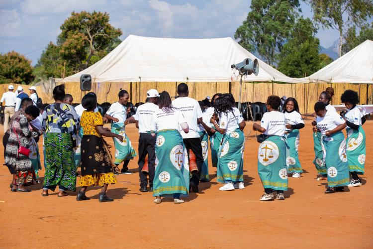 Ladies from the community and the Judiciary join together in dance